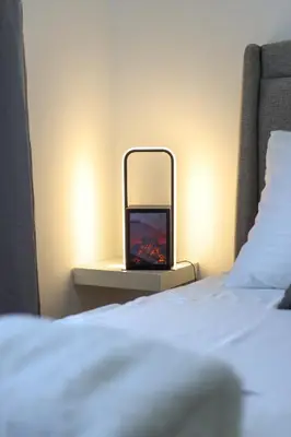 a tv sitting on a table next to a bed at Airport Belgrade Apartments in Surčin