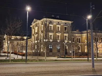 a large building with lights on the side of a street at Xena in Belgrade