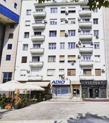 a large white building with an alido sign in front of it at Xena in Belgrade