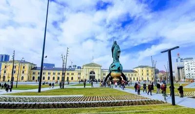 a group of people walking around a building with a statue at Xena in Belgrade