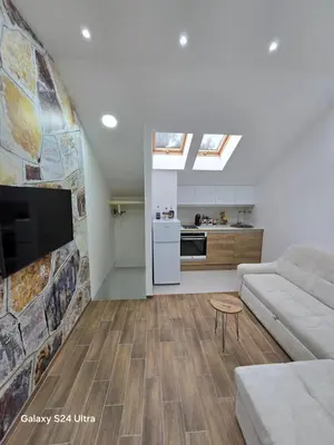 a living room with a couch and a kitchen at IDILA SPA New Belgrade in Novi Beograd