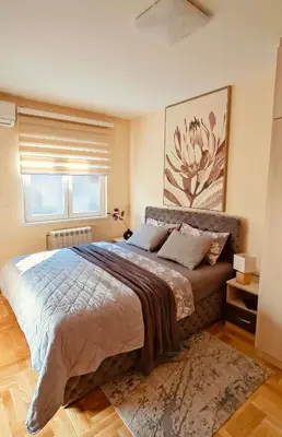a bedroom with a large bed and a window at Medison in Belgrade