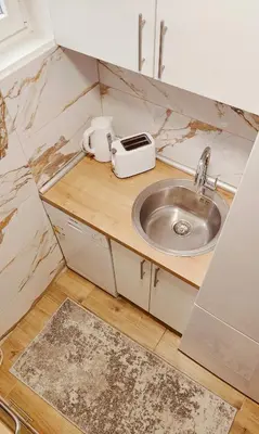 a small kitchen with a sink and a toaster at Medison in Belgrade
