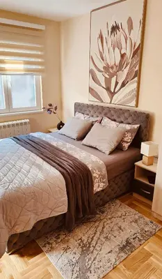 a bedroom with a bed and a painting on the wall at Medison in Belgrade