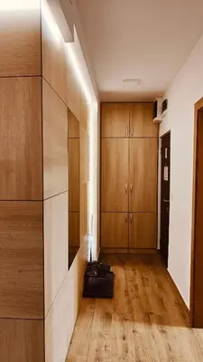 a room with wooden cabinets and a hallway with wood floors at Medison in Belgrade