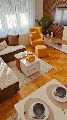 a living room with a couch and a table at Medison in Belgrade