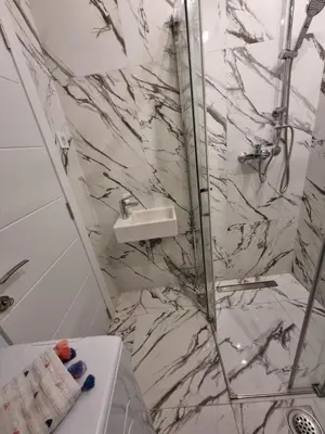 a bathroom with a marble shower and a toilet at Jela in Belgrade