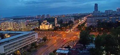 a city at night with traffic on a street at Jela in Belgrade