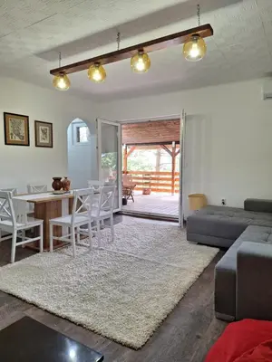 a living room with a couch and a table at Šumska Kosmaj in Nemenikuće