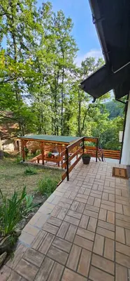 a patio with a picnic table and a fence at Šumska Kosmaj in Nemenikuće