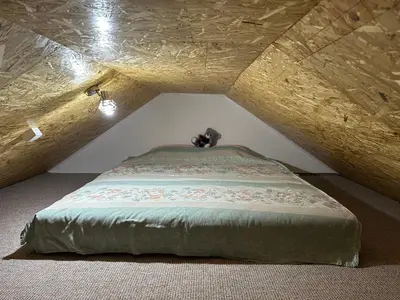 a bedroom with a bed in an attic at Apartman Aerodrom in Surčin