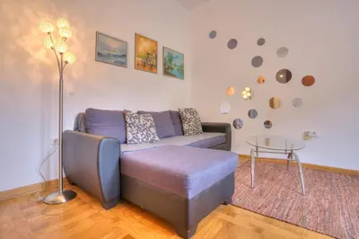 a living room with a couch and a table at Vračar Central Apartment in Belgrade