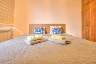 a bedroom with a bed with two pillows on it at Vračar Central Apartment in Belgrade