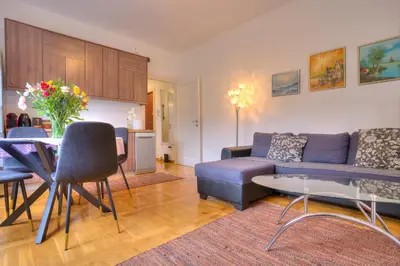 a living room with a couch and a table at Vračar Central Apartment in Belgrade