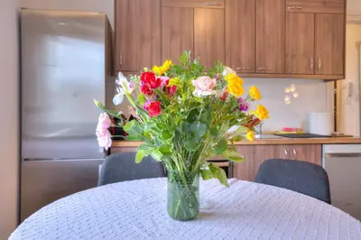 a vase filled with flowers sitting on a table at Vračar Central Apartment in Belgrade
