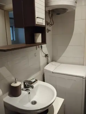 a small bathroom with a sink and a toilet at Apartman Nera in Stara Pazova