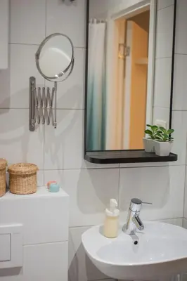 a bathroom with a sink and a mirror at URBAN GREEN Corner with a Story in Belgrade