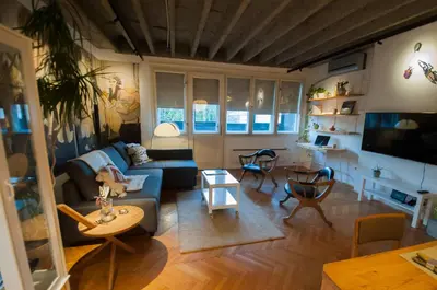 a living room with a couch and a table at URBAN GREEN Corner with a Story in Belgrade