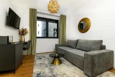 a living room with a couch and a television at URBAN DOWNTOWN luxury center Belgrade in Belgrade