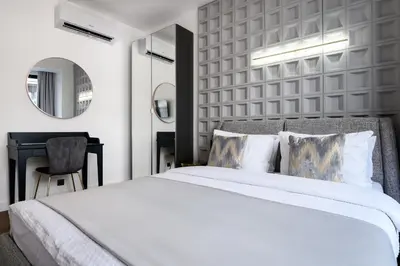 a bedroom with a large white bed and a desk at URBAN DOWNTOWN luxury center Belgrade in Belgrade