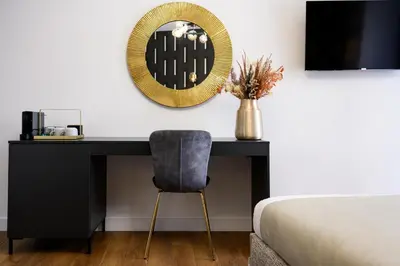 a bedroom with a desk with a mirror and a chair at URBAN DOWNTOWN luxury center Belgrade in Belgrade