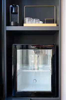a black microwave oven with a glass container inside at URBAN DOWNTOWN luxury center Belgrade in Belgrade