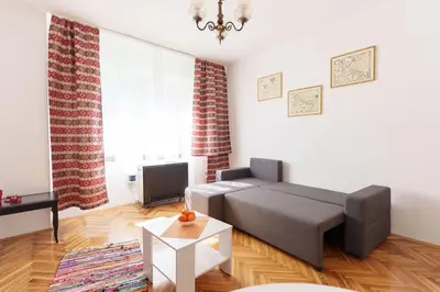 a living room with a couch and a tv at Budislav lovely apartment in Belgrade