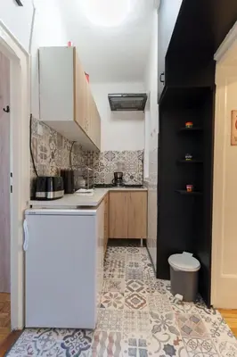a kitchen with a white refrigerator and a tile floor at Budislav lovely apartment in Belgrade