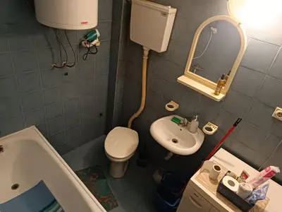 a small bathroom with a toilet and a sink at GOLD Apartman in Mirijevo