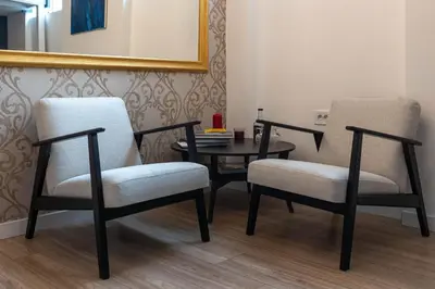 two chairs and a table in a room at Sunflower Apartment in Belgrade