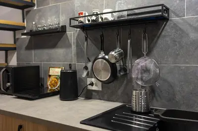 a kitchen counter with a sink and utensils at Sunflower Apartment in Belgrade