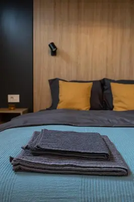 a pile of towels sitting on top of a bed at Sunflower Apartment in Belgrade