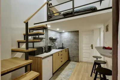 a kitchen with a loft conversion with a staircase at Sunflower Apartment in Belgrade