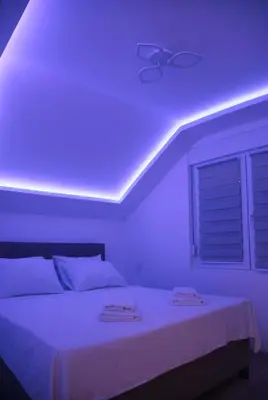 a room with a bed with a purple ceiling at Golden hill Vinča in Vinča