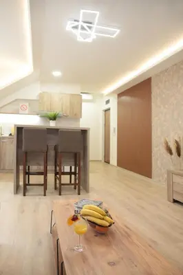 a living room with a table with bananas on it at Golden hill Vinča in Vinča