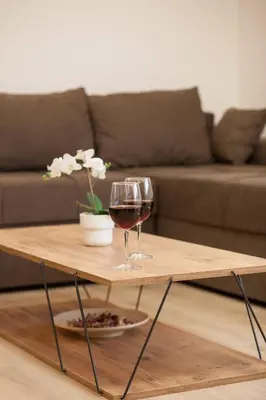a coffee table with two glasses of wine on it at Golden hill Vinča in Vinča