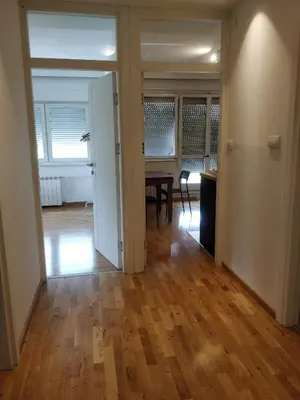 an empty living room with a table and a dining room at TikTok in Voždovac