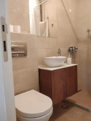 a bathroom with a white sink and a toilet at TikTok in Voždovac