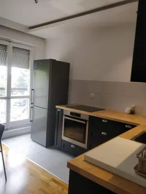 a kitchen with a stainless steel refrigerator and a stove at TikTok in Voždovac