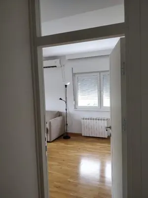an open door to a living room with a window at TikTok in Voždovac
