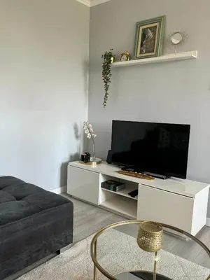 a living room with a tv on a white entertainment center at Ada View in Belgrade