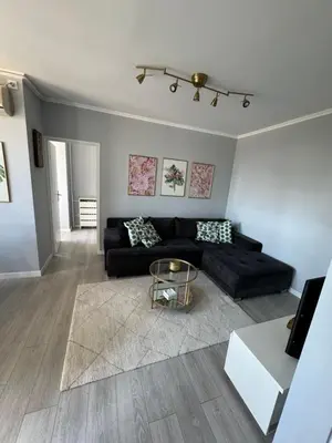 a living room with a black couch and a table at Ada View in Belgrade