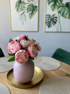 a vase filled with pink flowers on a table at Ada View in Belgrade