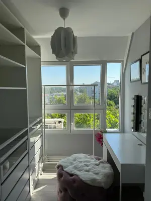a white room with a desk and a large window at Ada View in Belgrade