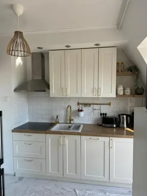 a kitchen with white cabinets and a sink at Ada View in Belgrade