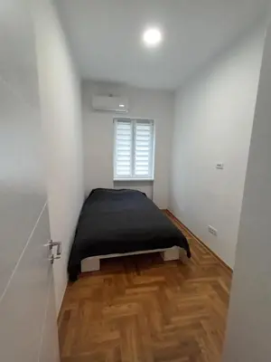 a bedroom with a bed with a black blanket at Gorana 1 in Belgrade