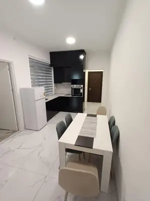 a kitchen with a white table and chairs in a room at Gorana 1 in Belgrade