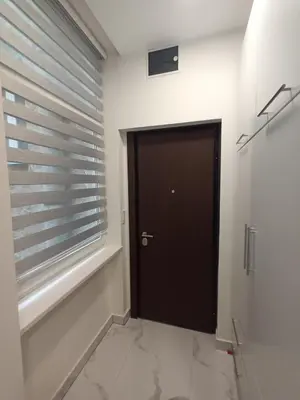 a hallway with a black door and a window at Gorana 1 in Belgrade