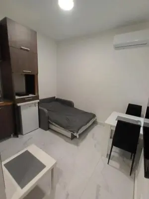 a small living room with a bed and a table at Gorana 1 in Belgrade