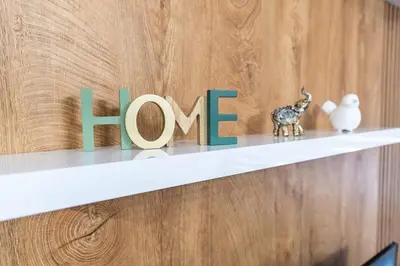 a shelf with the word love with figurines on it at Apartman Kolarević in Arandjelovac